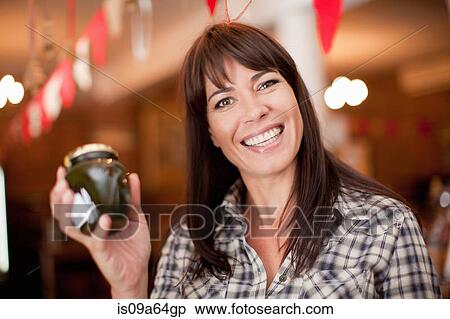 Stock Photography - Woman holding jar of preserves. Fotosearch