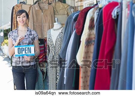 Woman holding open sign by store View Large Photo Image Picture - Woman holding open sign by store. Fotosearch