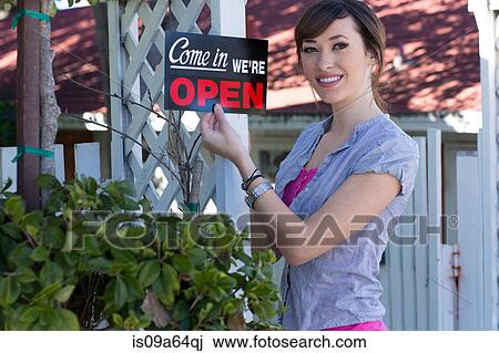 Woman holding open sign outdoors View Large Photo Image Stock Image - Woman holding open sign outdoors. Fotosearch
