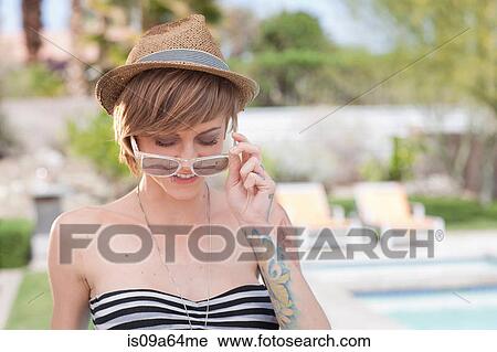 Woman in bikini wearing sunglasses View Large Photo Image Stock Image - Woman in bikini wearing sunglasses. Fotosearch