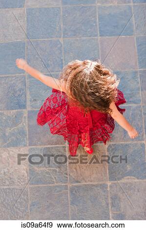 Stock Photo - Woman in gown spinning outdoors. Fotosearch