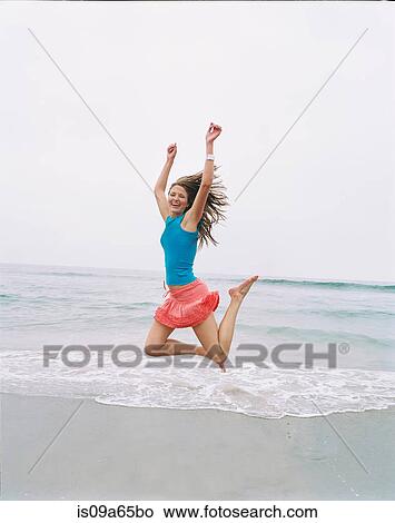 Woman jumping for joy on beach View Large Photo Image Picture - Woman jumping for joy on beach. Fotosearch