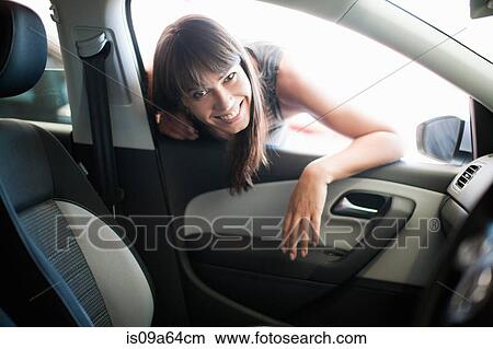 Woman leaning in car window View Large Photo Image Picture - Woman leaning in car window. Fotosearch