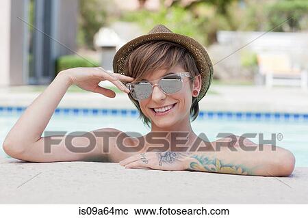 Woman leaning on edge of pool View Large Photo Image Stock Image - Woman leaning on edge of pool. Fotosearch