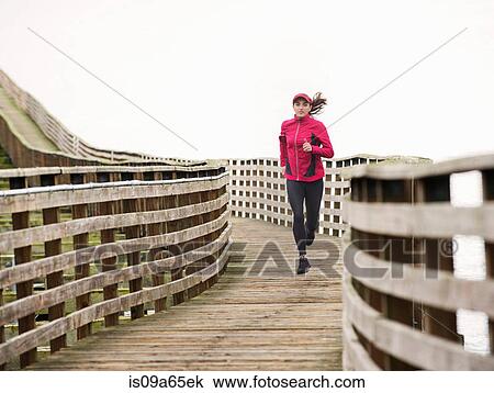 Woman running on wooden dock View Large Photo Image Stock Image - Woman running on wooden dock. Fotosearch