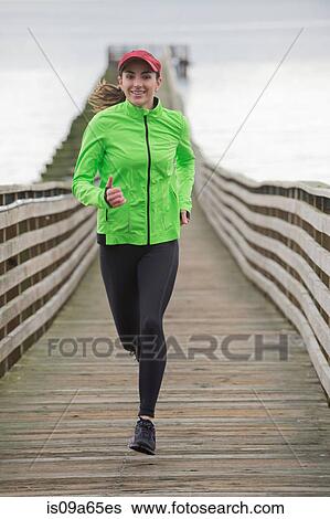 Woman running on wooden dock View Large Photo Image Stock Photograph - Woman running on wooden dock. Fotosearch