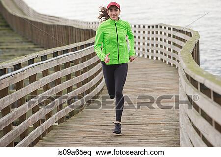 Woman running on wooden dock View Large Photo Image Stock Photography - Woman running on wooden dock. Fotosearch