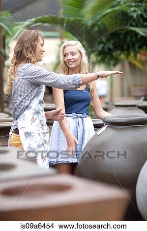 Picture - Woman shopping for planters. Fotosearch