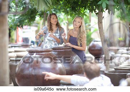 Picture - Woman shopping for planters. Fotosearch