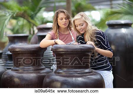Stock Photo - Woman shopping for planters. Fotosearch