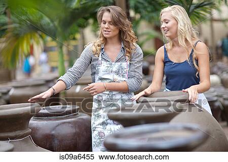 Stock Photography - Woman shopping for planters. Fotosearch
