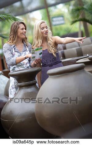 Stock Photography - Woman shopping for planters. Fotosearch