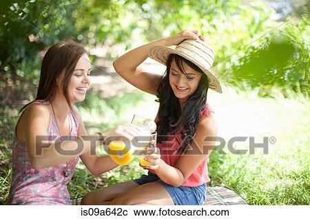 Women picnicking together in park View Large Photo Image Stock Image - Women picnicking together in park. Fotosearch