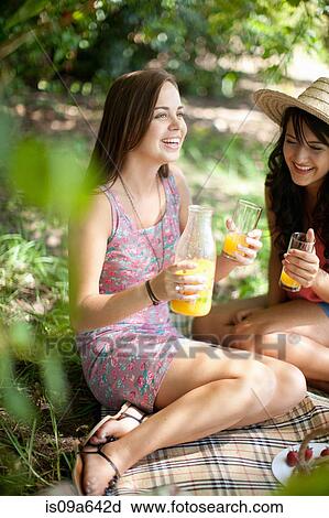 Women picnicking together in park View Large Photo Image Stock Image - Women picnicking together in park. Fotosearch