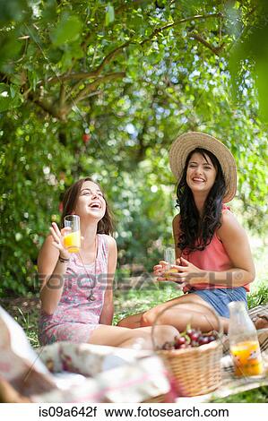Women picnicking together in park View Large Photo Image Stock Image - Women picnicking together in park. Fotosearch