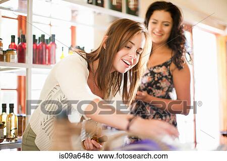 Stock Image - Women shopping in grocery store. Fotosearch