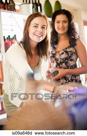 Stock Image - Women shopping in grocery store. Fotosearch
