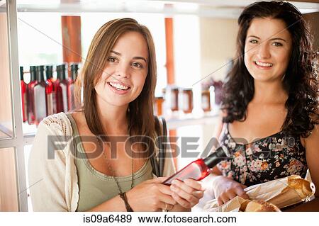 Women shopping in grocery store View Large Photo Image Stock Photo - Women shopping in grocery store. Fotosearch