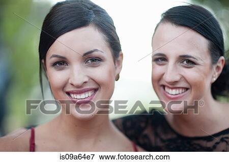 Stock Photo - Women smiling together outdoors. Fotosearch