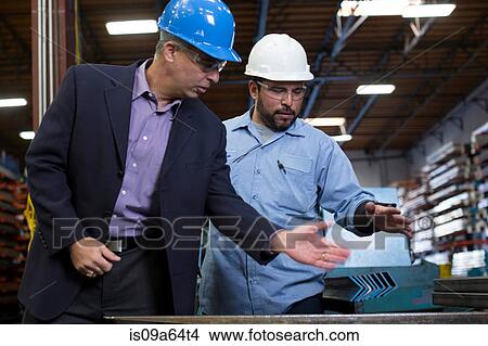 Picture - Worker and businessman in metal plant. Fotosearch