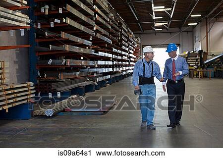 Worker and businessman in metal plant View Large Photo Image Stock Image - Worker and businessman in metal plant. Fotosearch