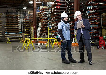 Stock Photo - Worker and businessman in metal plant. Fotosearch