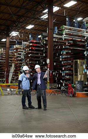 Worker and businessman in metal plant View Large Photo Image Stock Photo - Worker and businessman in metal plant. Fotosearch