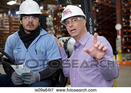 Worker and businessman in metal plant View Large Photo Image Stock Photo - Worker and businessman in metal plant. Fotosearch