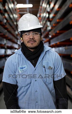Worker standing in metal plant View Large Photo Image Stock Image - Worker standing in metal plant. Fotosearch