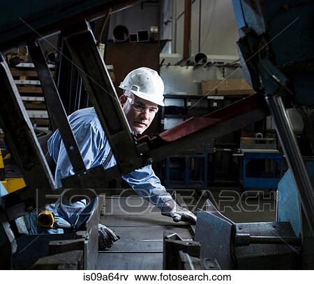 Worker using machinery in metal plant View Large Photo Image Stock Photo - Worker using machinery in metal plant. Fotosearch