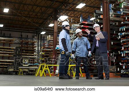 Workers and businessman in metal plant View Large Photo Image Stock Image - Workers and businessman in metal plant. Fotosearch