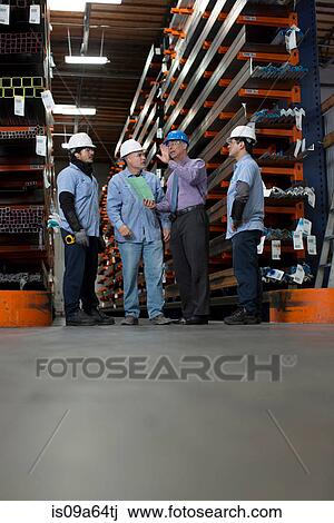 Workers and businessman in metal plant View Large Photo Image Stock Image - Workers and businessman in metal plant. Fotosearch