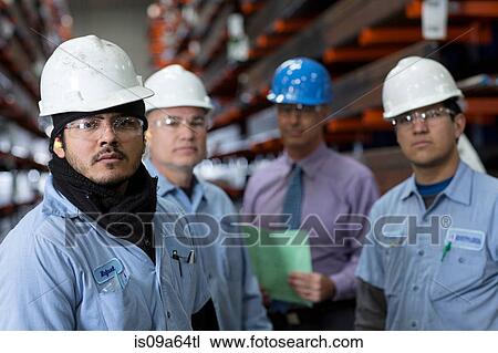 Stock Image - Workers and businessman in metal plant. Fotosearch