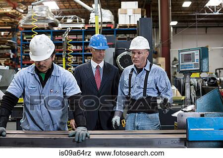 Workers and businessman in metal plant View Large Photo Image Stock Photo - Workers and businessman in metal plant. Fotosearch