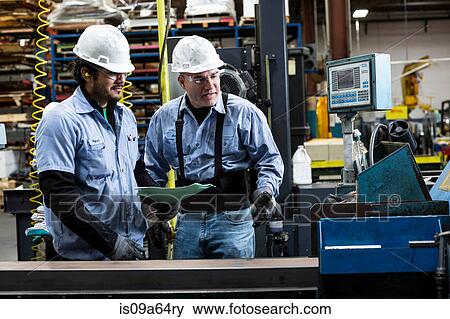 Workers talking in metal plant View Large Photo Image Stock Photo - Workers talking in metal plant. Fotosearch