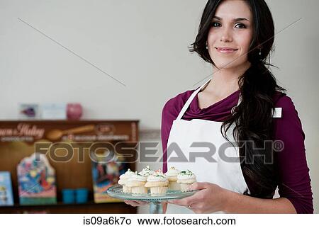 Baker holding tray of cupcakes View Large Photo Image Picture - Baker holding tray of cupcakes. Fotosearch