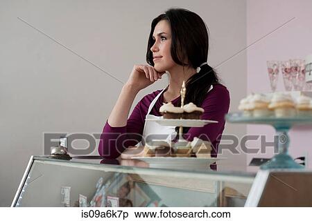 Baker standing behind counter View Large Photo Image Stock Photography - Baker standing behind counter. Fotosearch