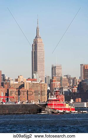 Barge floating by New York City skyline View Large Photo Image Stock Image - Barge floating by New York City skyline. Fotosearch