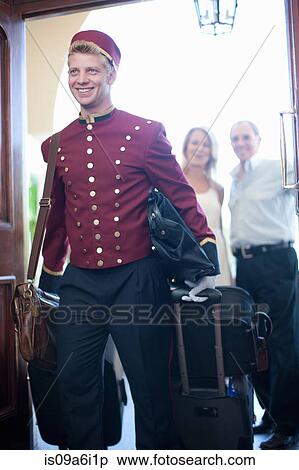 Bellhop carrying luggage in hotel View Large Photo Image Stock Photography - Bellhop carrying luggage in hotel. Fotosearch