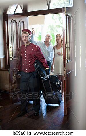 Bellhop carrying luggage in hotel View Large Photo Image Stock Photography - Bellhop carrying luggage in hotel. Fotosearch