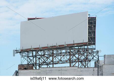 Stock Image - Blank billboard on roof of building. Fotosearch