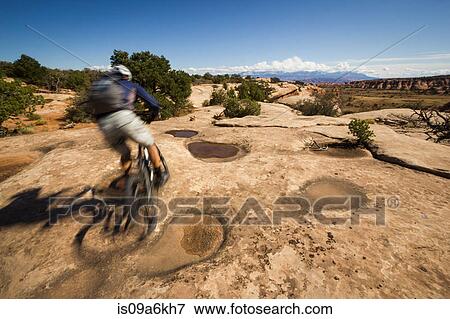 Stock Photo - Blurred view of mountain biker. Fotosearch