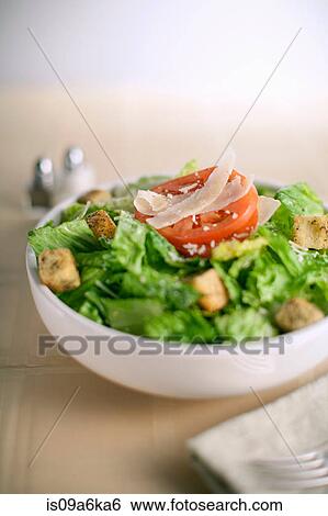 Stock Photograph - Bowl of salad on table. Fotosearch
