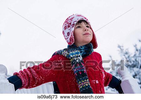 Stock Image - Boy playing in snow. Fotosearch