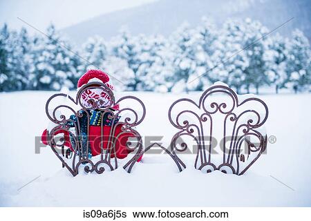Stock Photograph - Boy sitting in chair in snow. Fotosearch