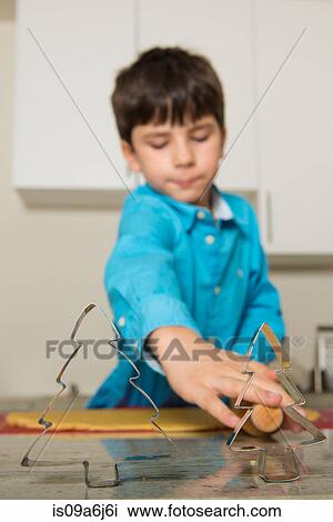 Boy using cookie cutters in kitchen View Large Photo Image Stock Image - Boy using cookie cutters in kitchen. Fotosearch