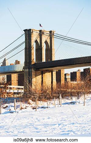 Stock Photo - Brooklyn Bridge and snowy park. Fotosearch