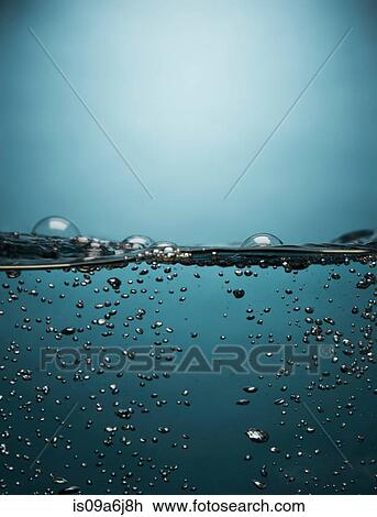 Stock Image - Bubbles floating in water. Fotosearch