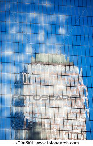 Stock Photograph - Building reflected in skyscraper windows. Fotosearch