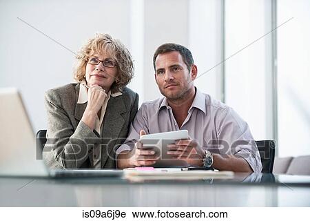 Stock Image - Business people listening in meeting. Fotosearch